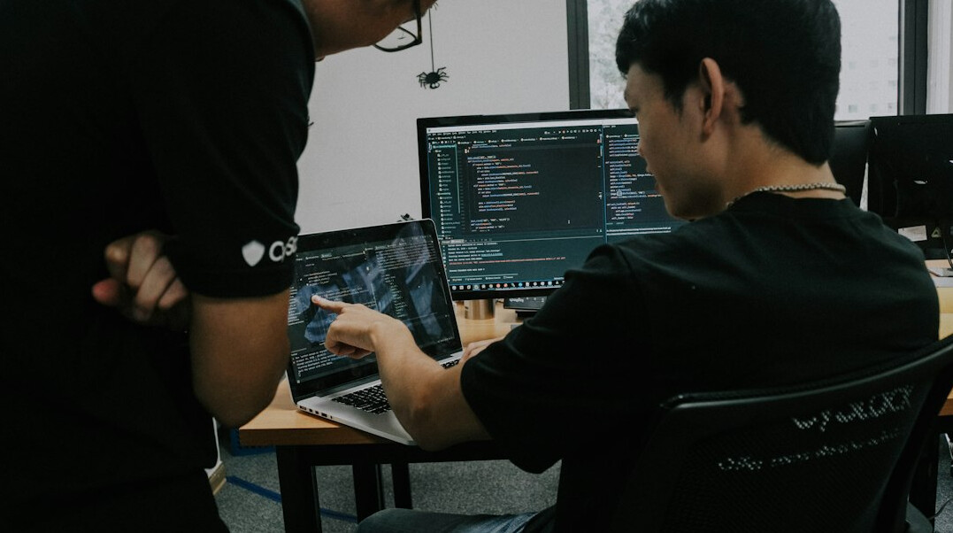 programmer coding on laptop