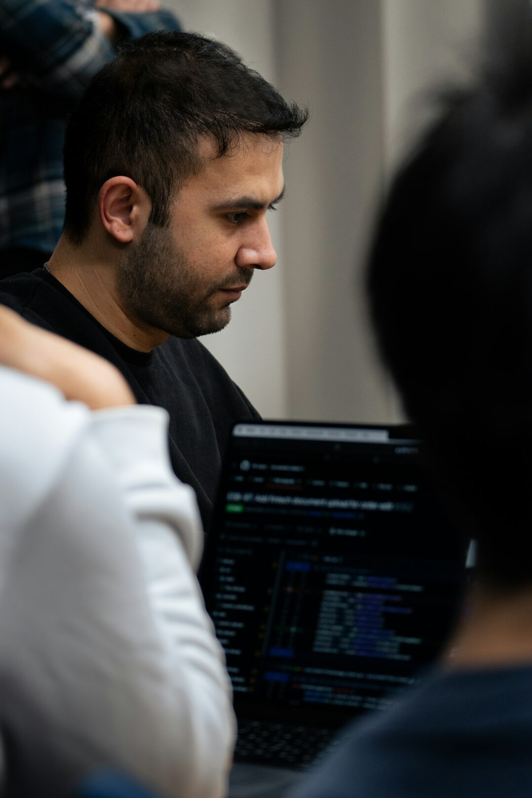 adult student coding on laptop